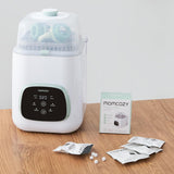 White baby bottle sterilizer with digital display on a wooden surface, accompanied by Momcozy packaging and packets.
